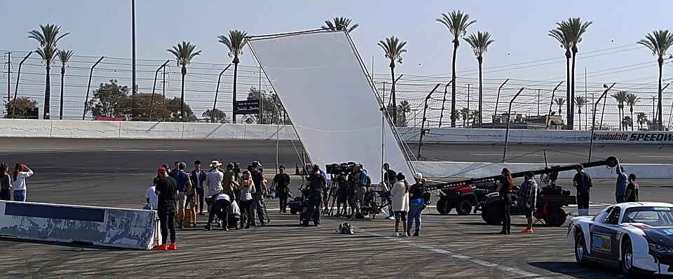 Behind the scenes photograph showing film crew at work on a professional production set
